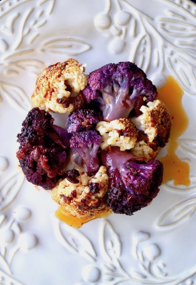 roasted purple and white cauliflower flowerets with a light red sauce