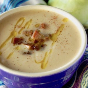 Coconut Kohlrabi Lemon Soup in a dark purple bowl