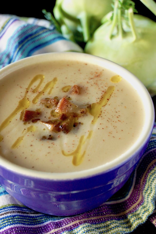 purple bowl iwth puréed kohlrabi soup, with a drizzle of oil