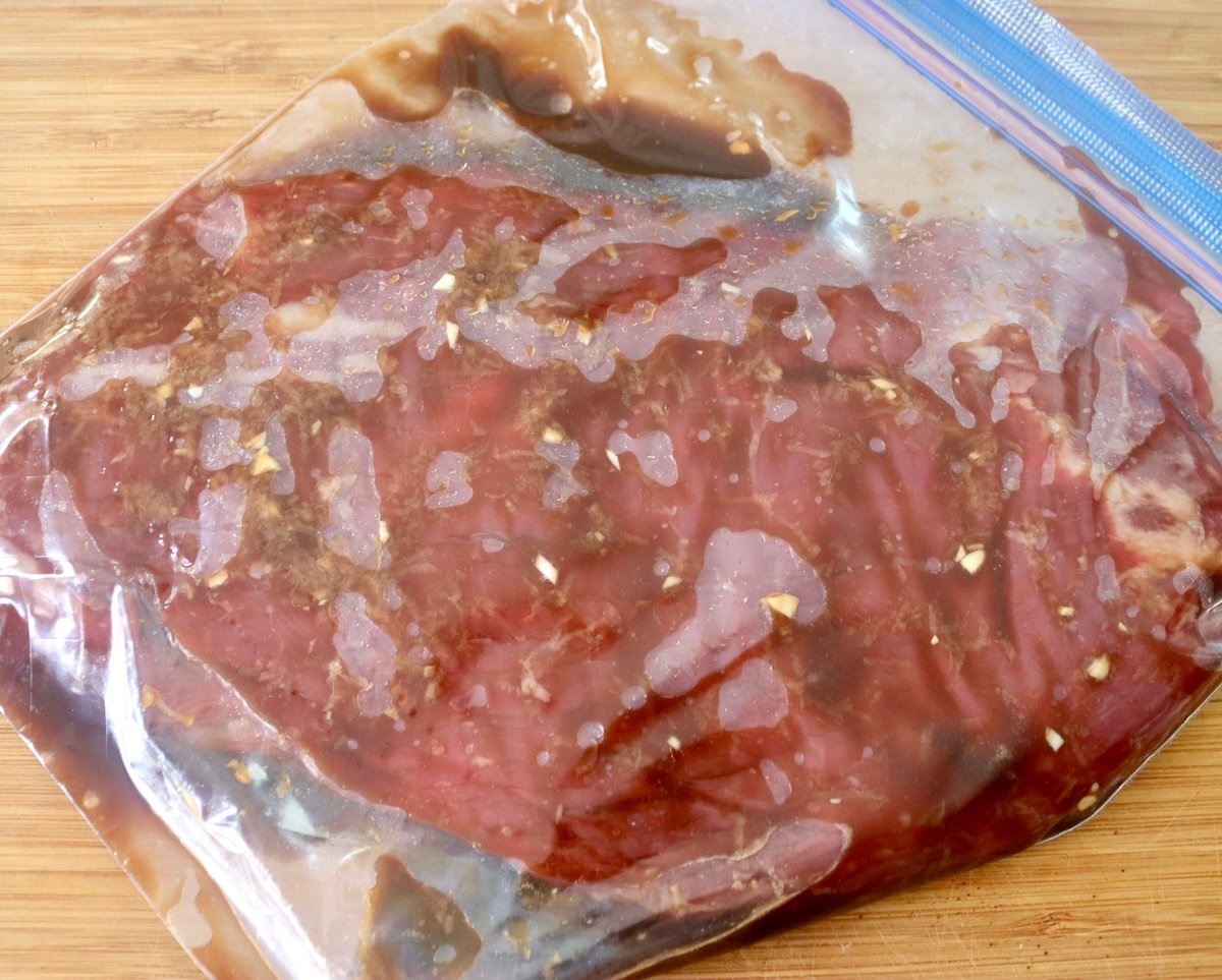 Flank steak with coffee marinade in a ziplok bag.