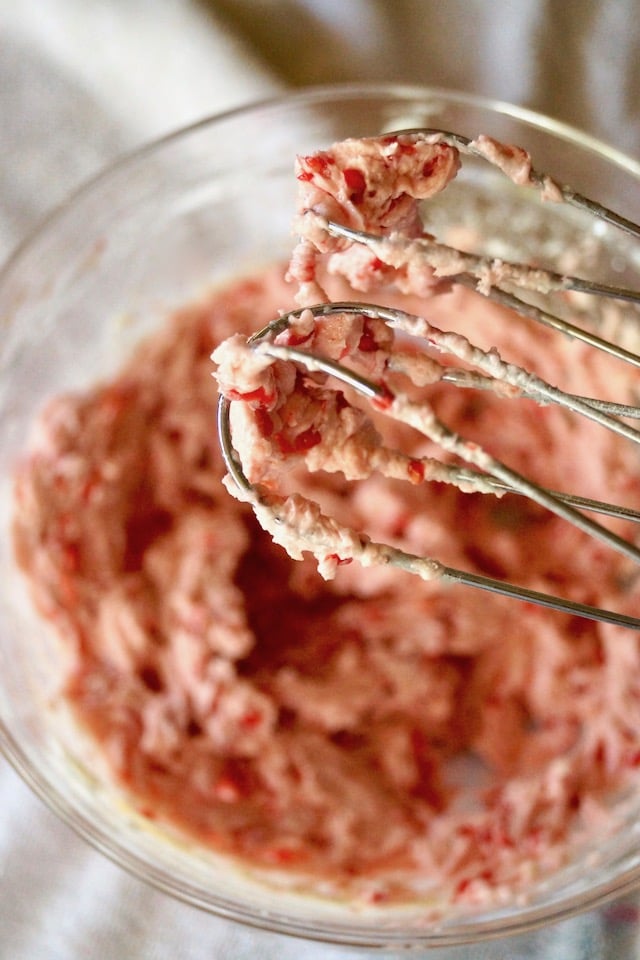 Valentine's Day Raspberry Chocolate Cookie batter in a glass bowl with electric mixer beaters.