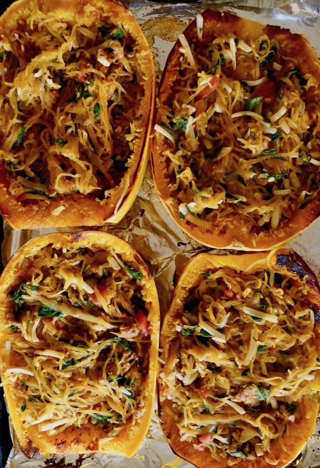 Four halves of Spaghetti squash filled with spinach, sausage and cheese.