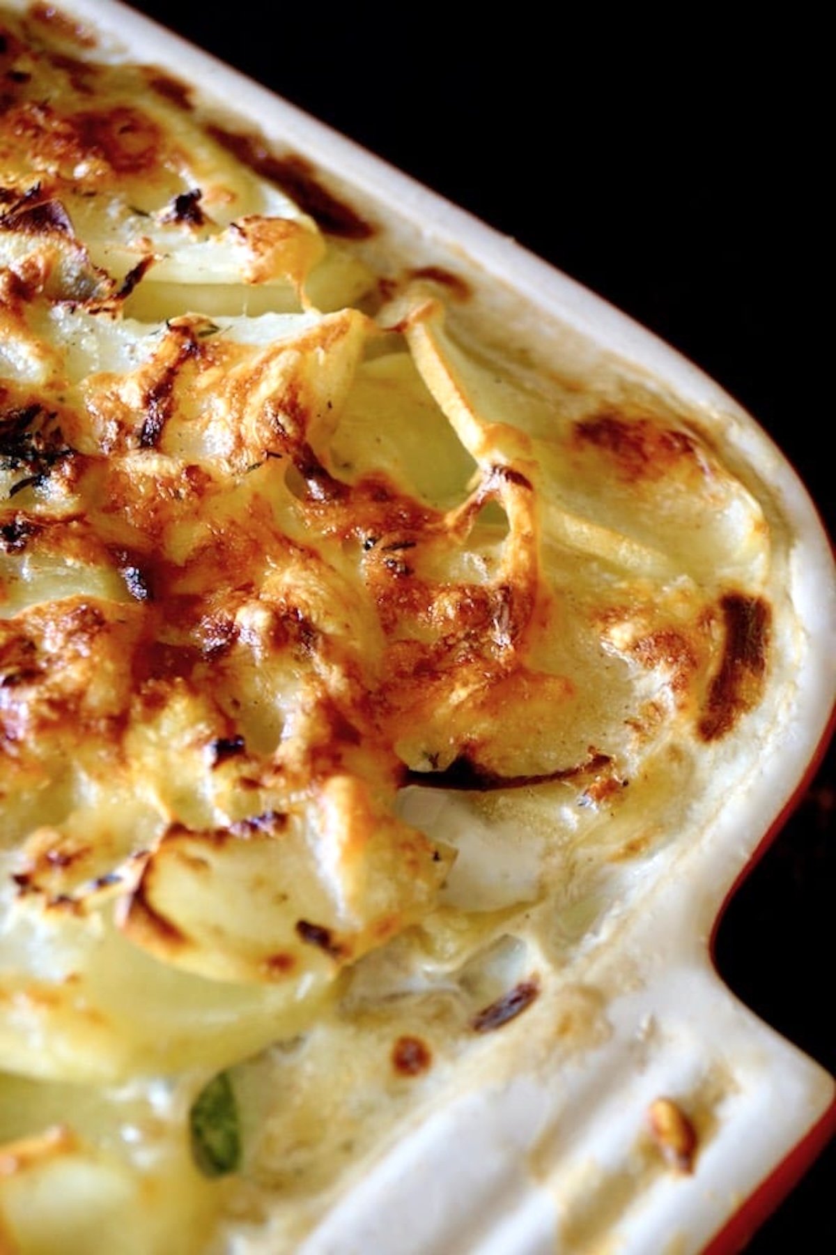 Golden brown potato gratin in a casserole dish.