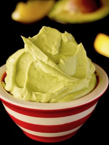 Creamy Avocado Butter in a red and white striped bowl.