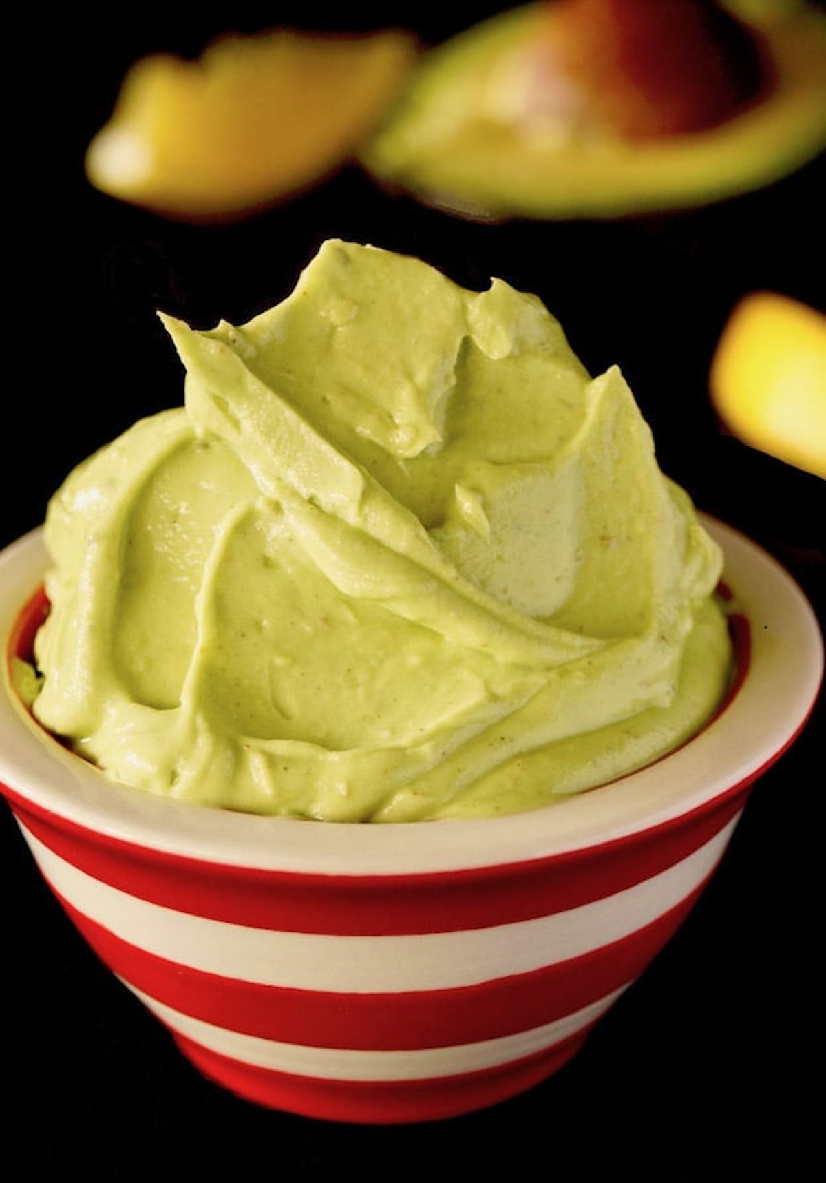 Creamy Avocado Butter in a red and white striped bowl.