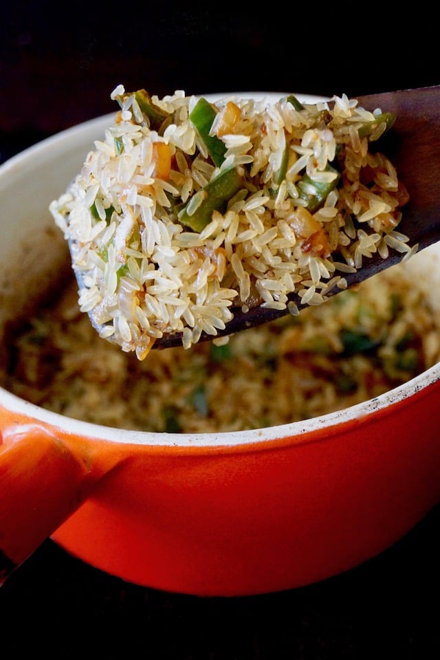 Mexican Poblano Rice Pliaf in an orange pot, just before being cooked.