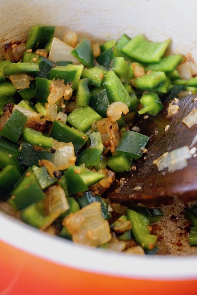 Raw chopped poblanos and onion for Mexican Poblano Rice Pliaf.