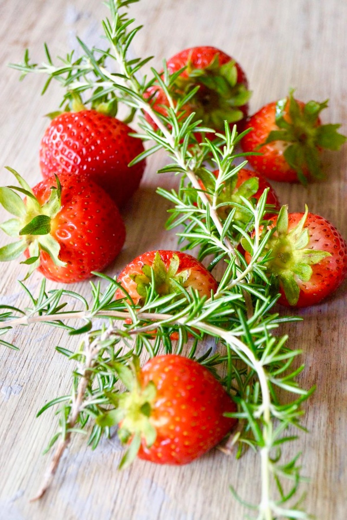 Big deep red strawberries and fresh rosemary sprigs.