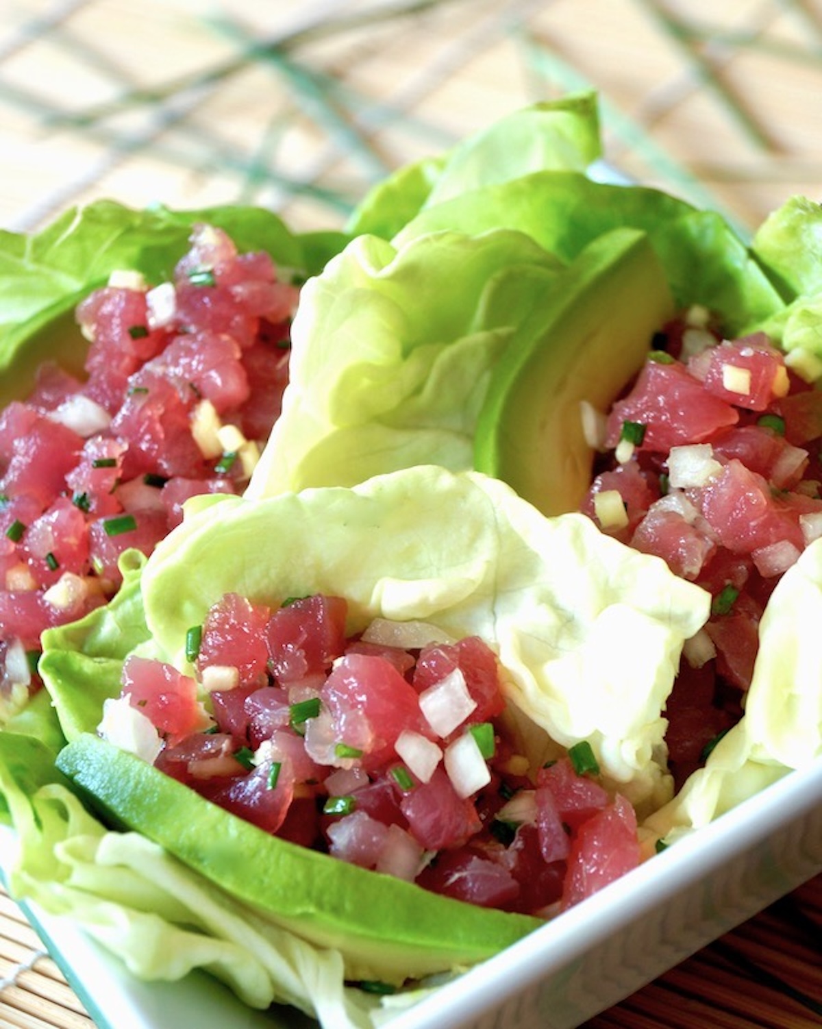 Ahi-Tuna-Tartare-with-Ginger Three Lettuce Cups with Ahi Tuna Tartare with bits of fresh ginger and onion.