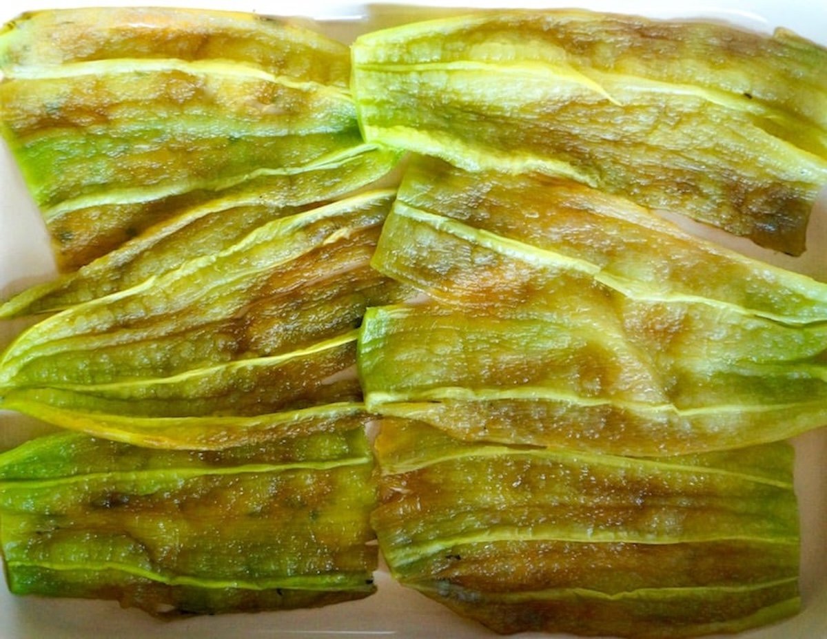 Layer of opened, roated and peeled hatch chiles in a casserole dish.