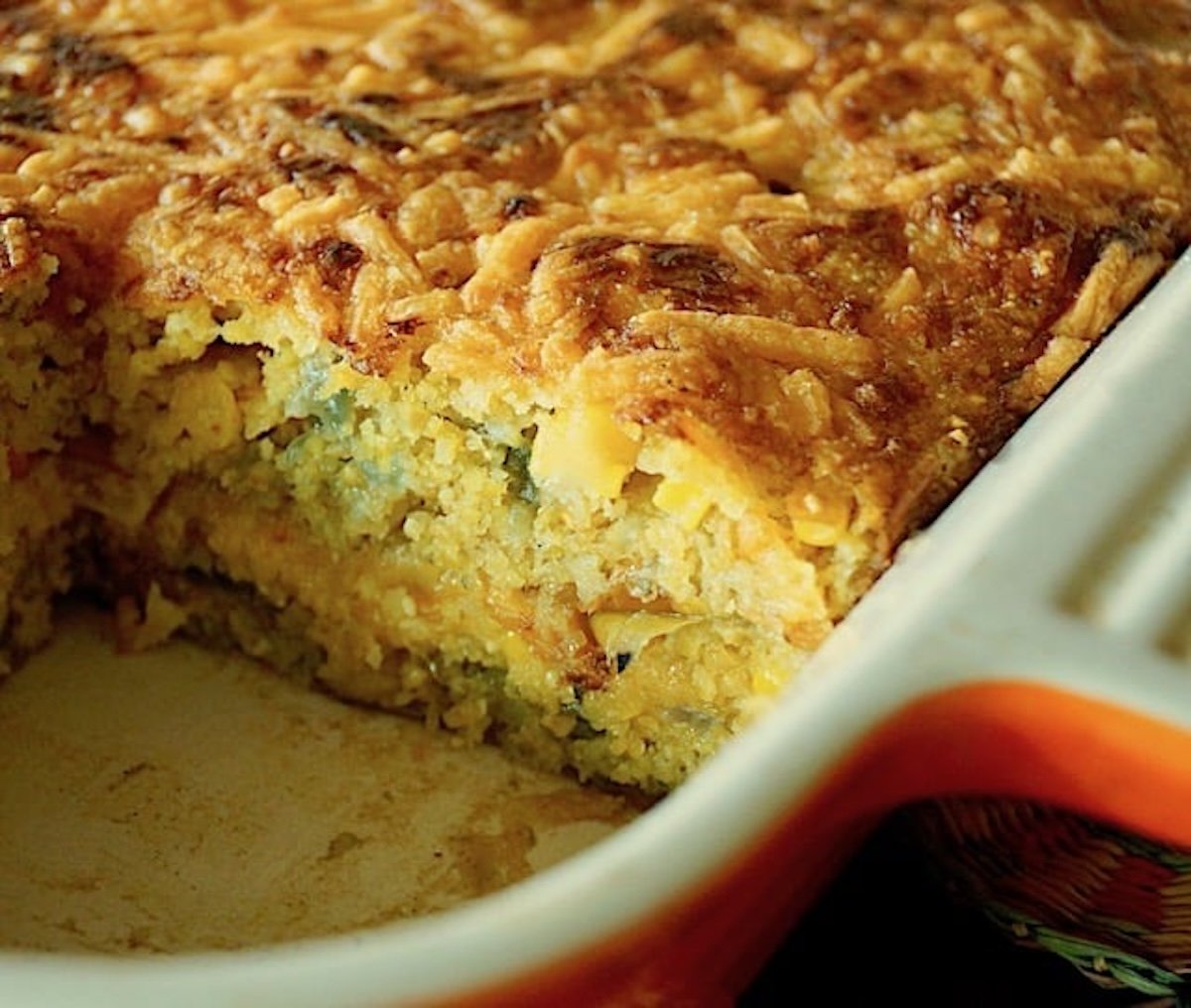 Hatch Chile Cornbread Casserole with one slice removed in pan.