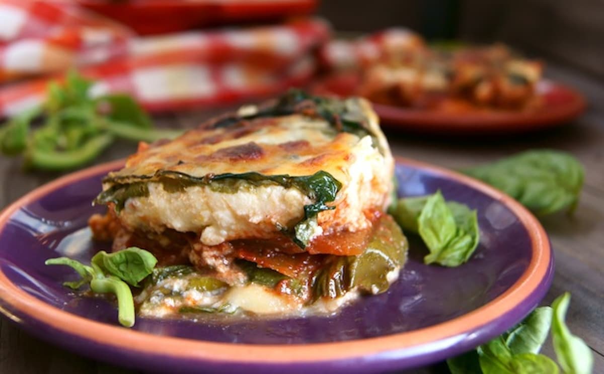 Swiss-Chard-Lasagna Slice of vegetarian Swiss chard lasagna on a purple plate.
