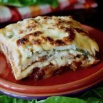 red plate with one square slice of swiss chard lasagna