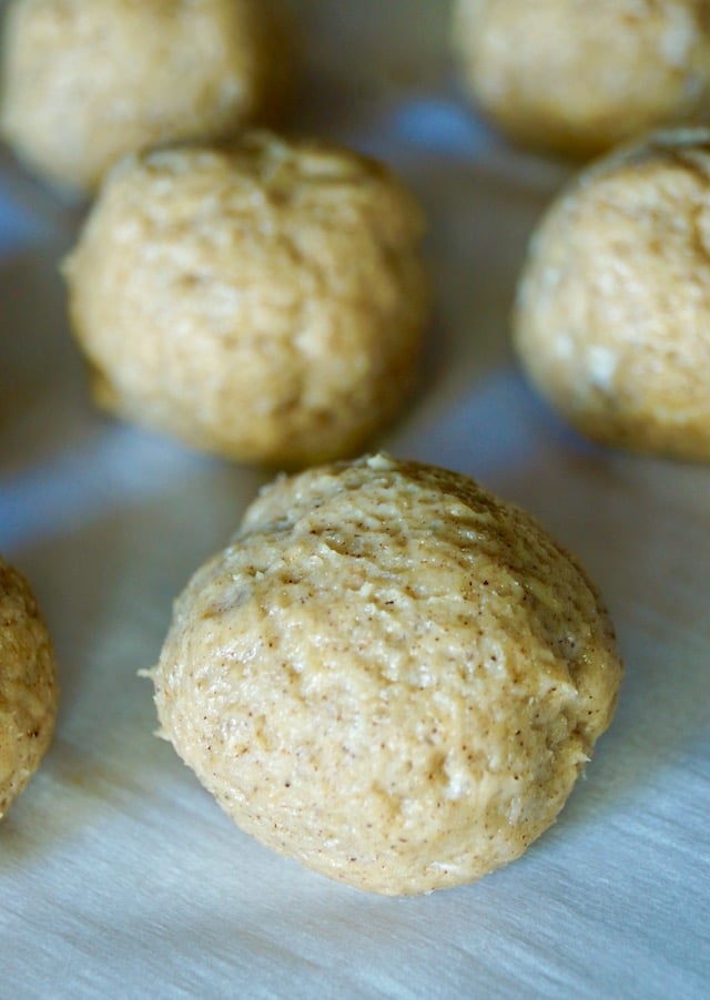 Close up of raw, shaped dough for Air Fried Pumpkin Spice Glazed Donut Holes, on parchment.