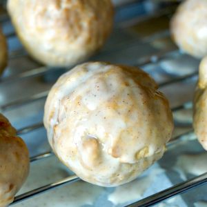 Glazed donut holes on a baking rack.