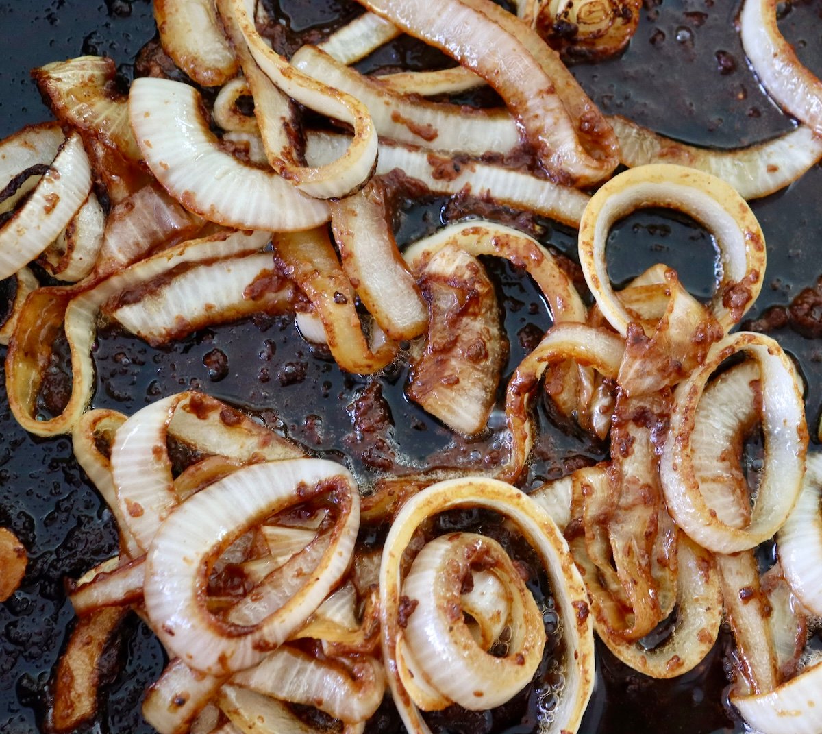 Thickly cut rings of onion in a cast iron skillet, caramelized.
