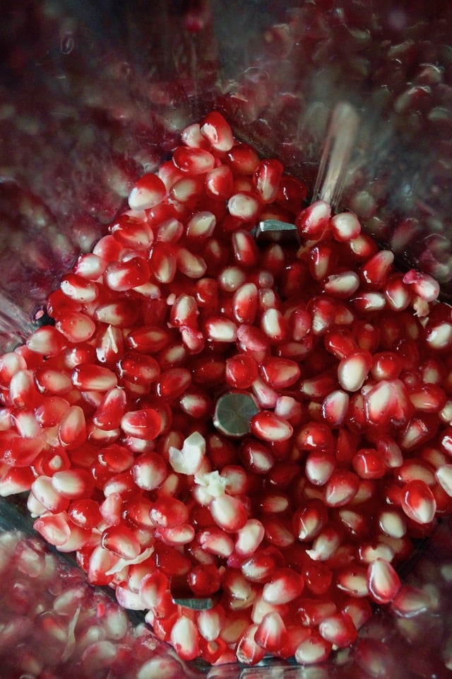 Pomegranate seeds in a blender.
