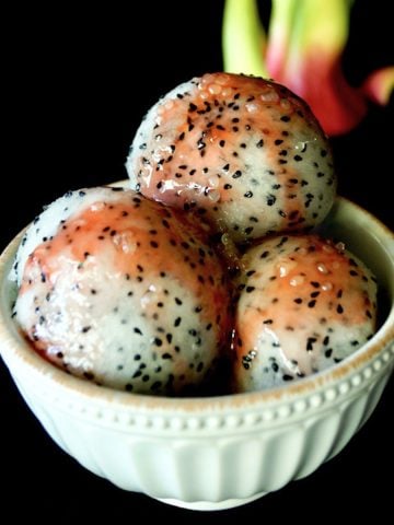 3 large scoops of dragon fruit with pomegranate glaze in a white bowl