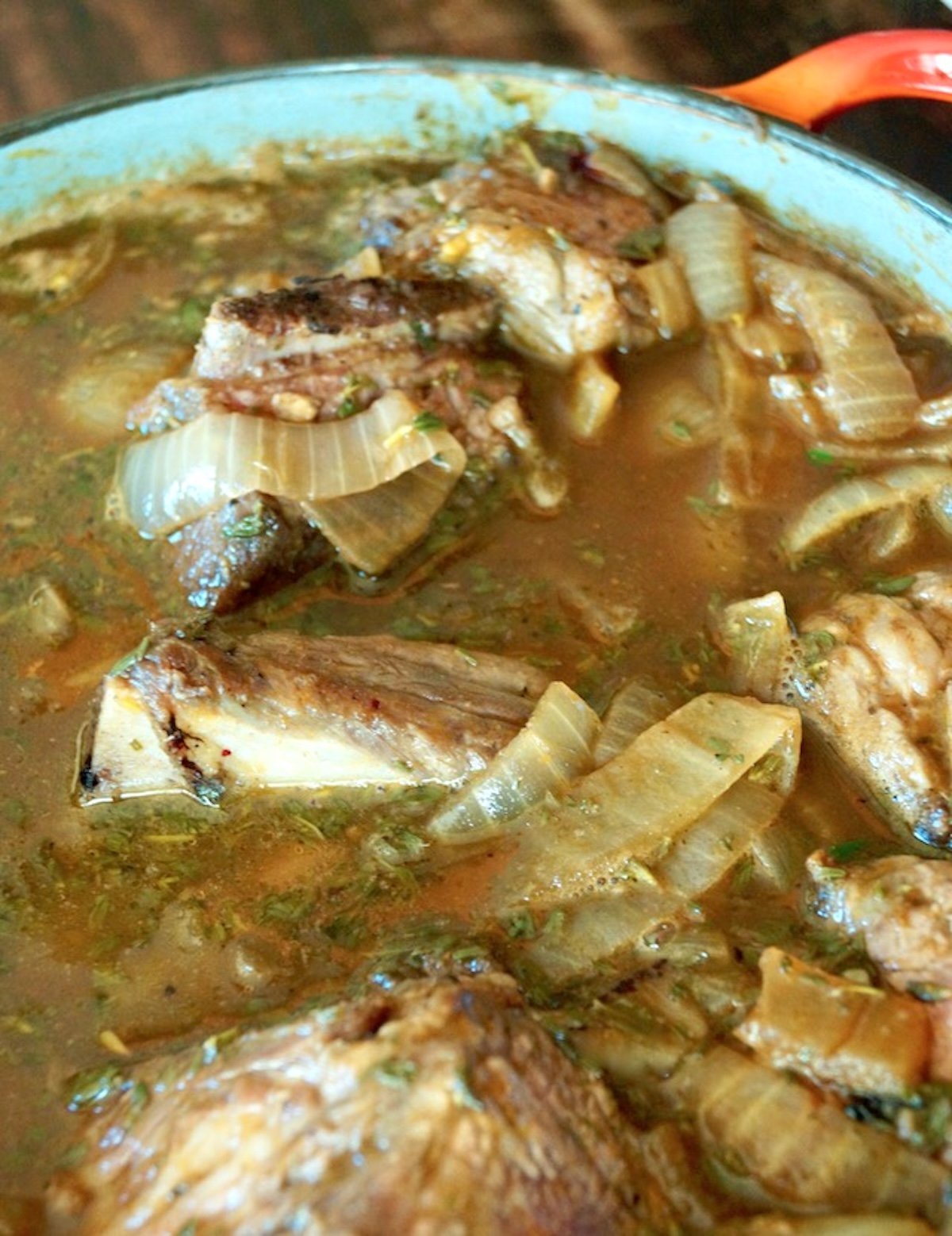 Short Rib Pumpkin Stew in a large Dutch Oven with lots of onions.