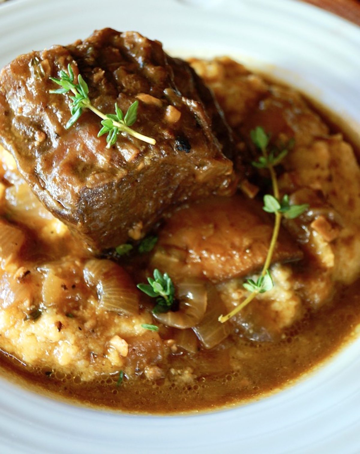 Pumpkin-Braised-Beef-Short-Ribs-Rpe Close up of braised beef short rib in white bowl.
