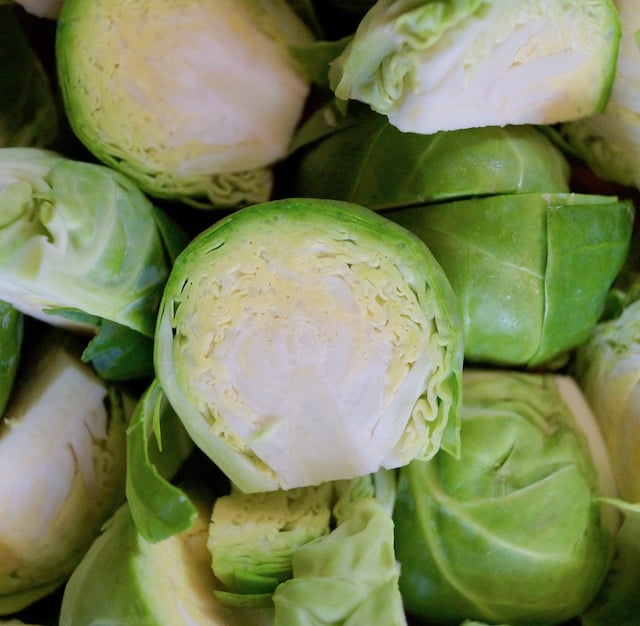 Raw brussels sprouts sliced in half.