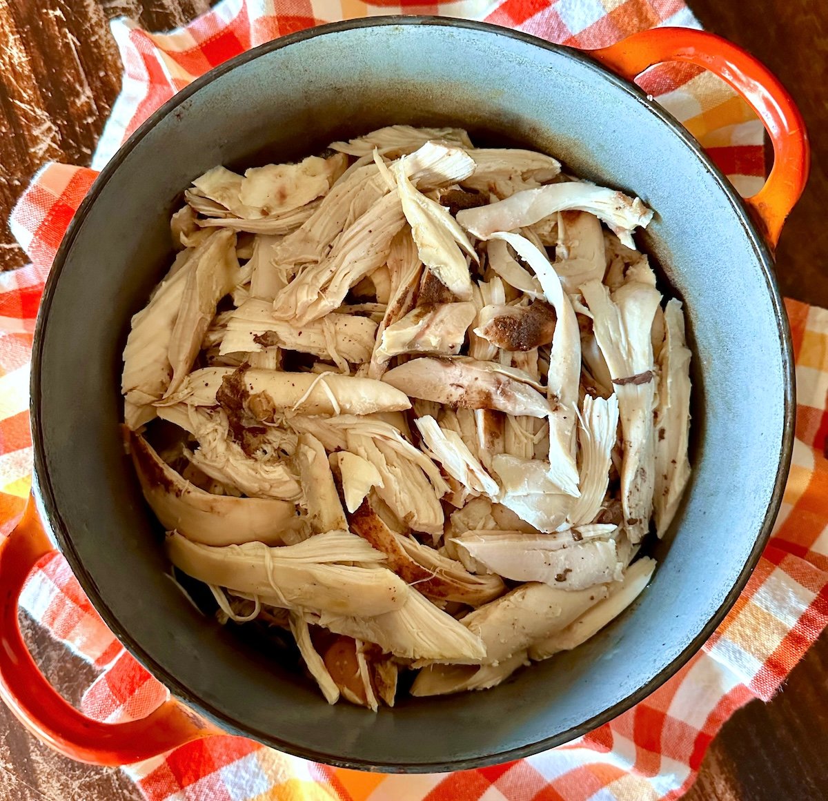 Top view of hredded chicken in a Dutch oven.