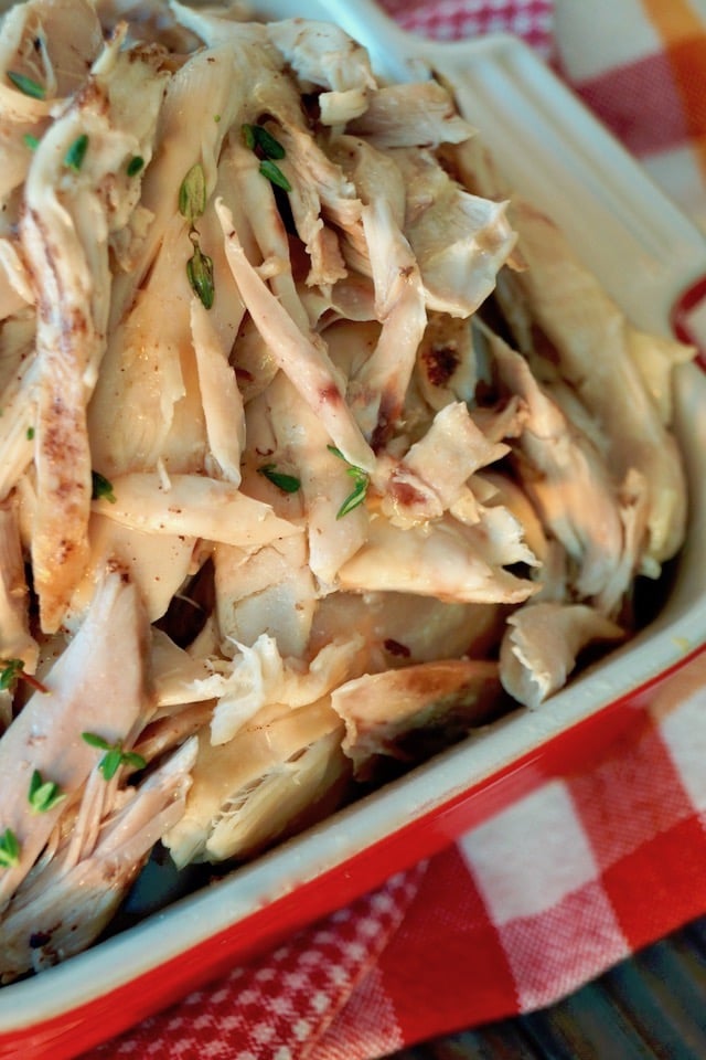 Shredded Fall Apart Dutch Oven Chicken in casserole dish. 