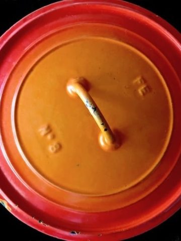 Top view of an orange Dutch Oven.