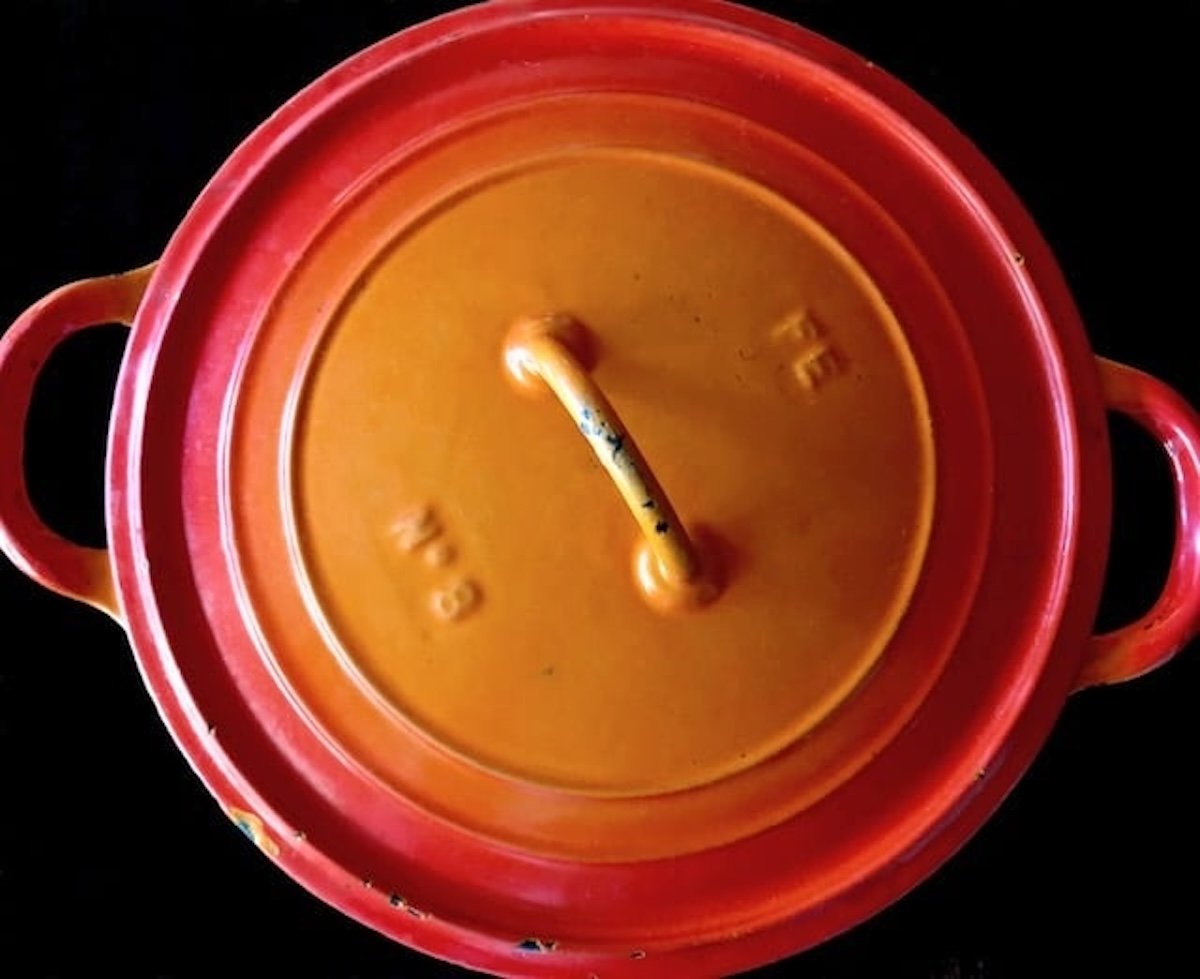 Top view of an orange Dutch Oven.