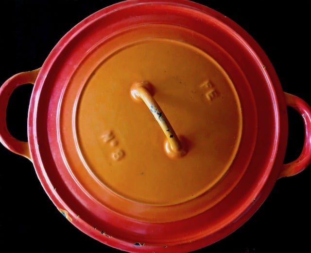 Top view of a fiery orange Dutch Oven.