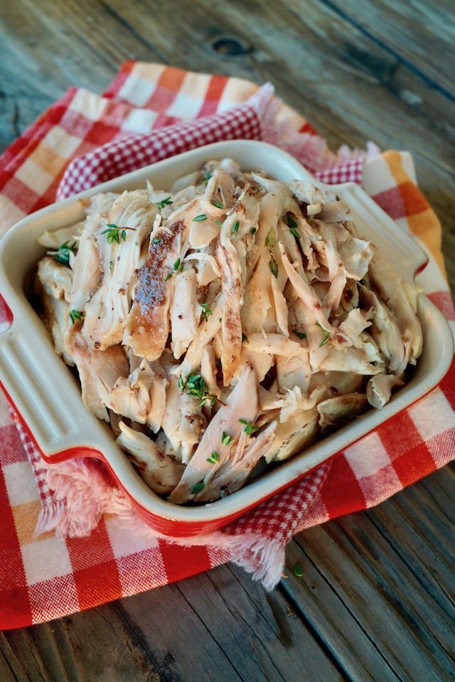 Shredded Fall Apart Dutch Oven Chicken in a square casserole dish.