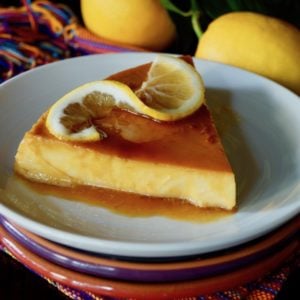 One slice of meyer lemon flan on white plate.