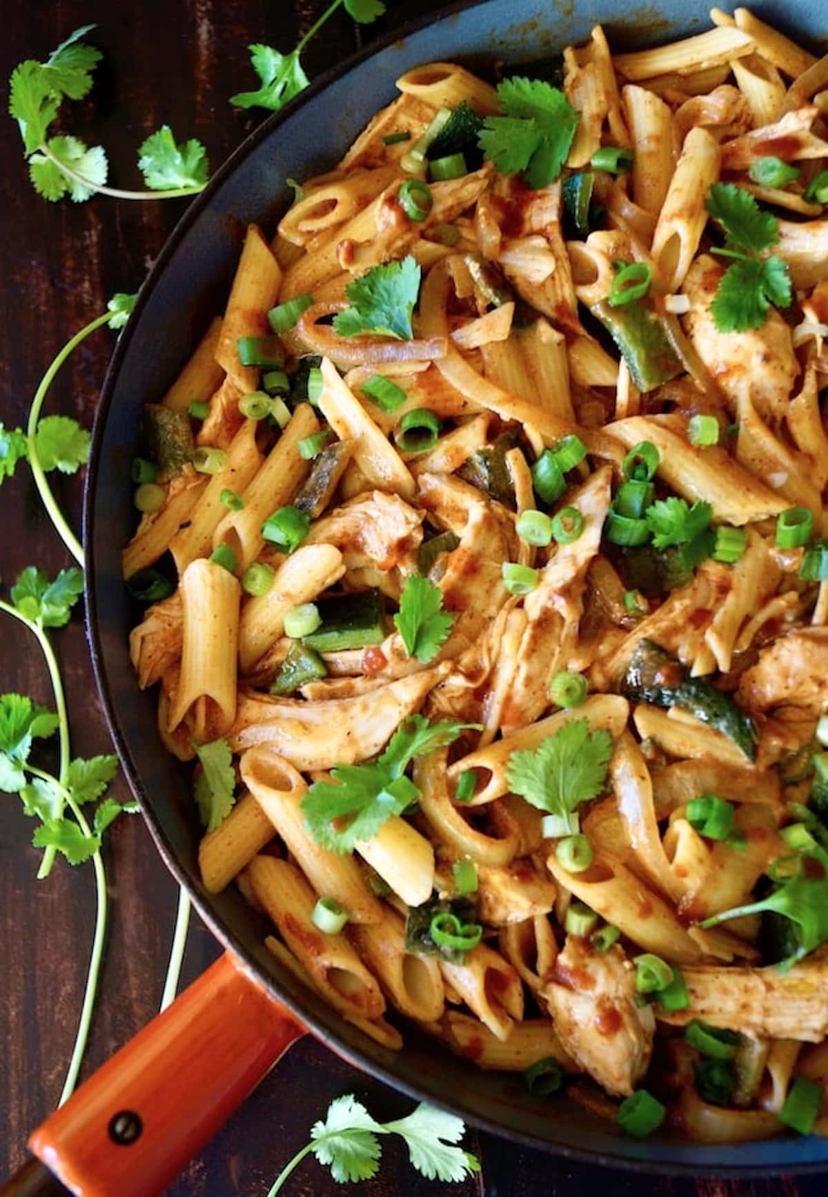Mexican-Chicken-Poblano-Pasta-Recipe Top view of Chicken Poblano Pasta in skillet with fresh cilantro.