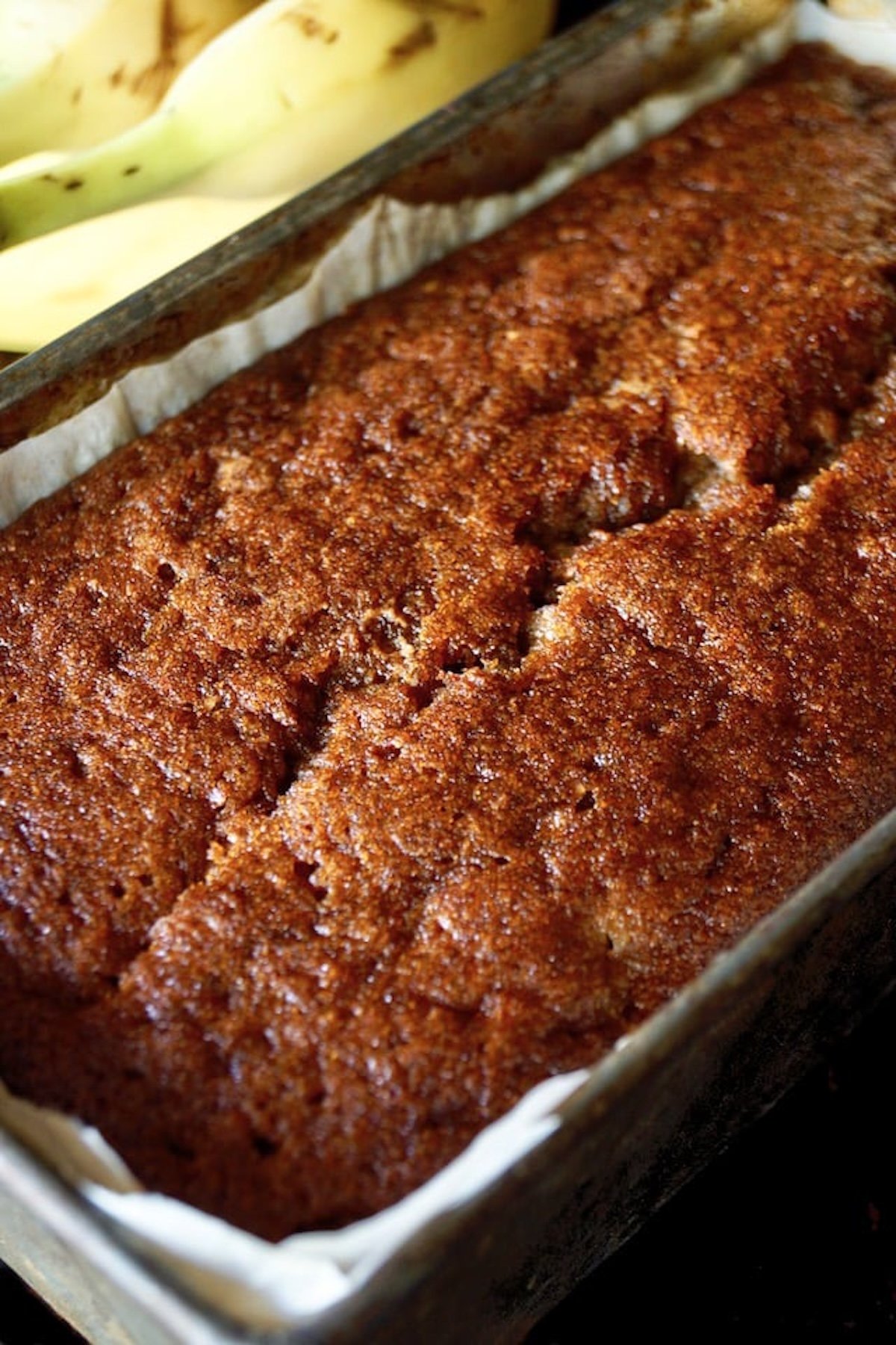 Baked, golden brown banana cake in a loaf pan.