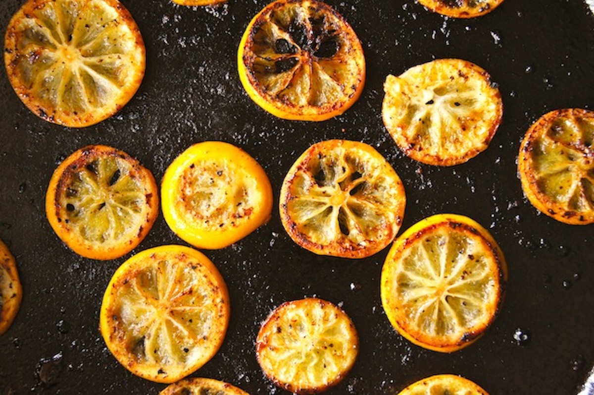 Fried-Lemon-Caesar-Salad-Recipe Fried lemon slices in a cast iron skillet.