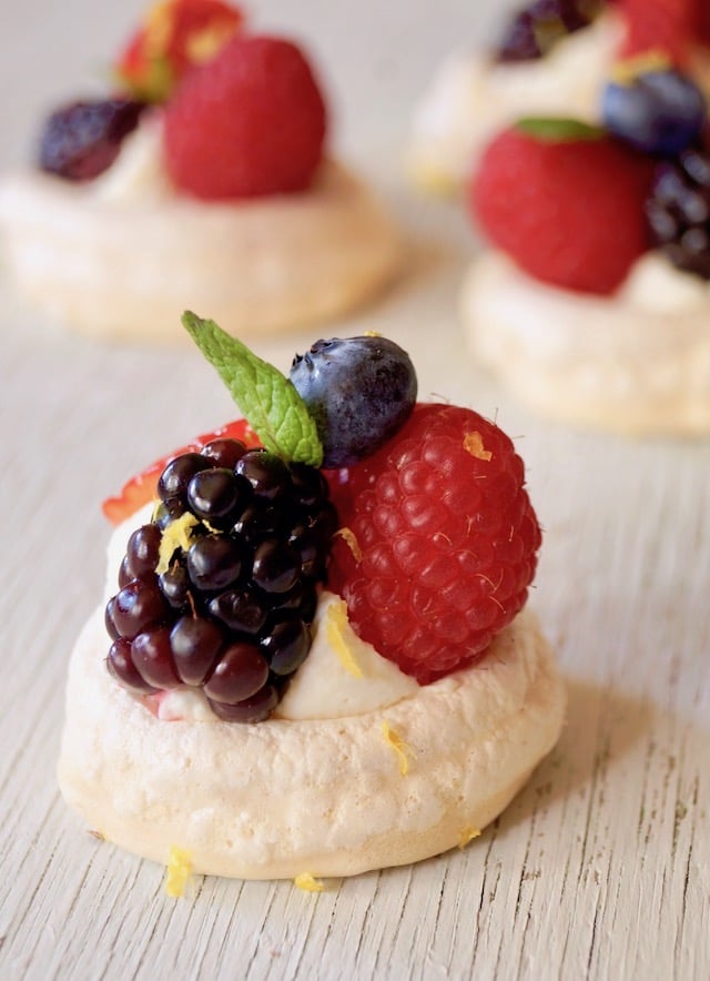 Close up of one Mini Lemon Berry Pavlova with mint leaf