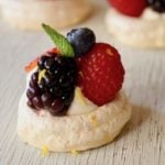 Close up of one Mini Lemon Berry Pavlova with mint leaf