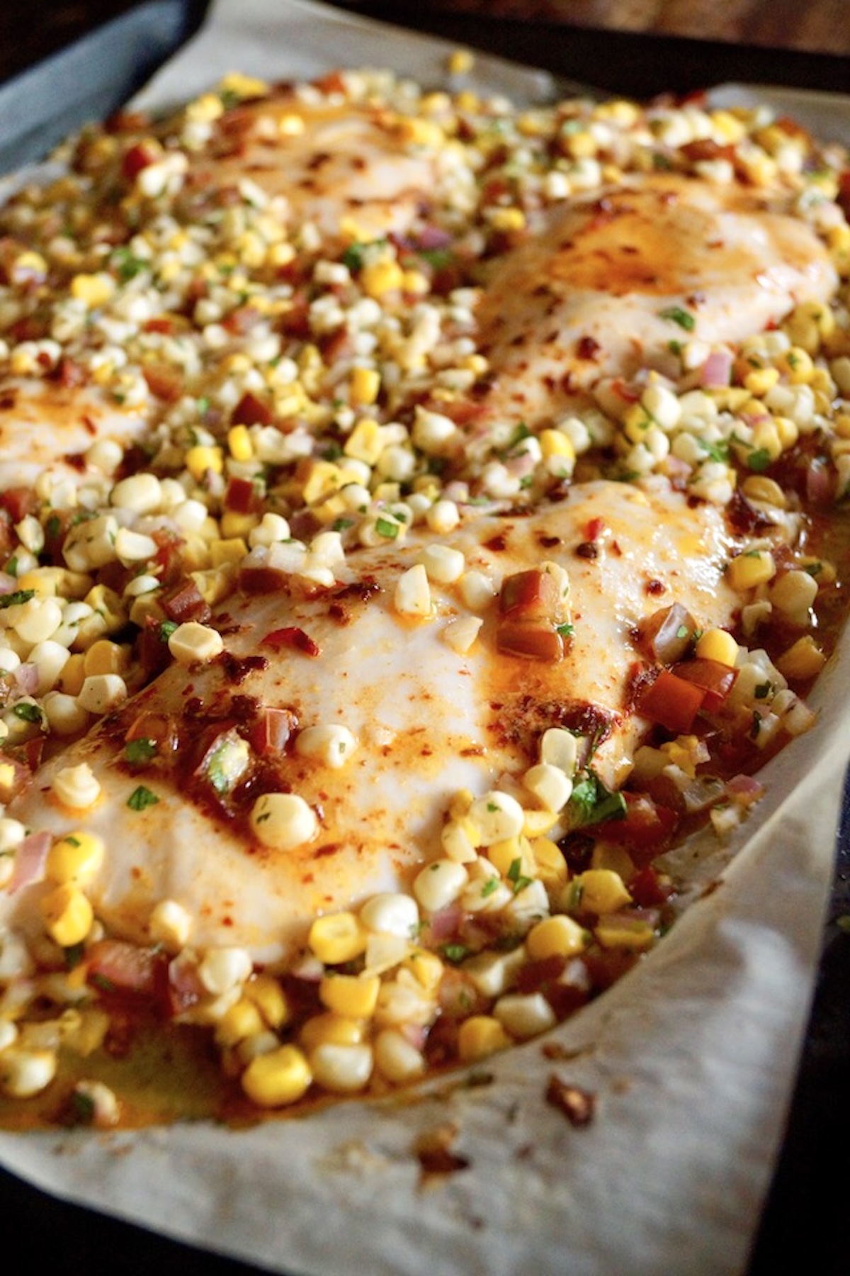 Sheet-Pan-Chipotle-Chicken-with-Corn-Salsa Close up of Sheet Pan Chipotle Chicken with Corn Salsa right out of the oven on the pan