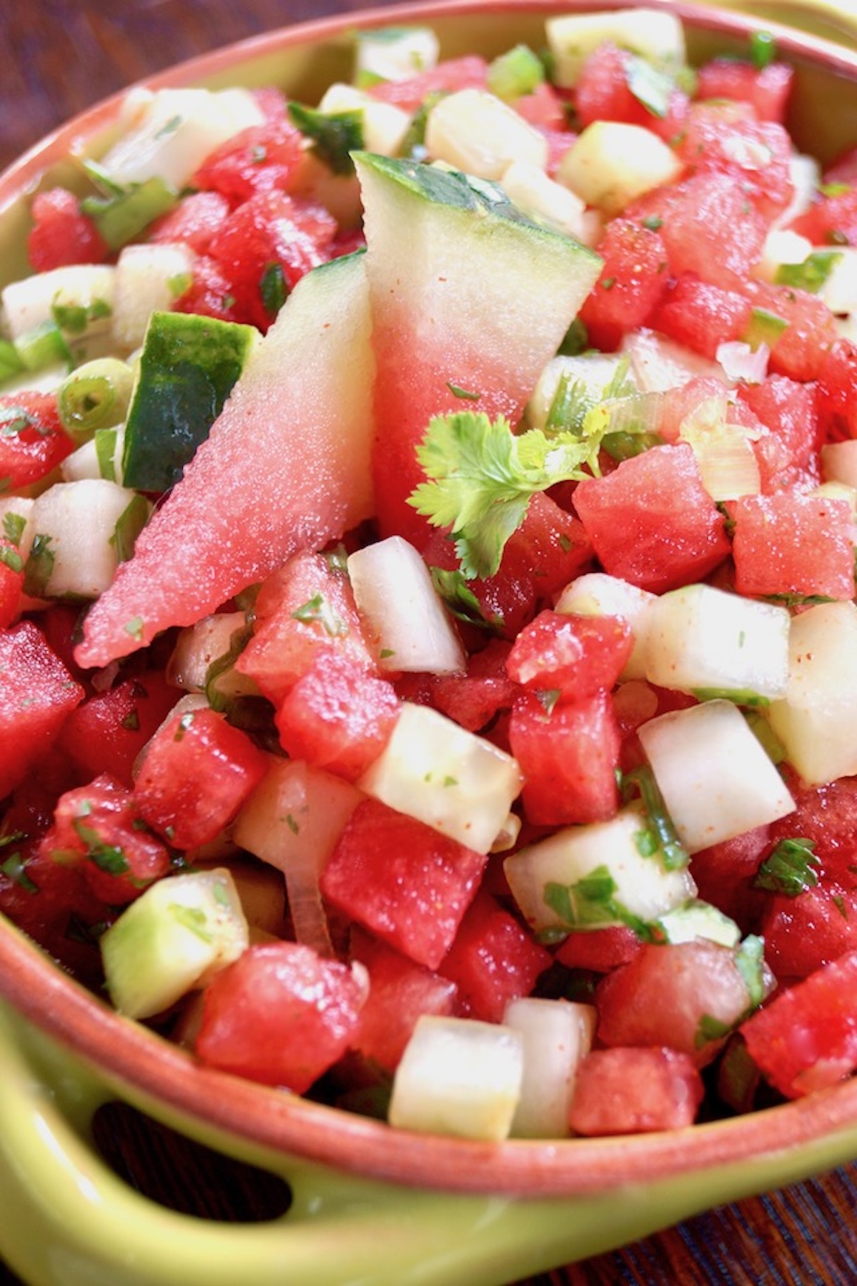 Watermelon-Cucumber-Salsa-Recipe Cucumber and watermelon salsa in a green bowl with a light brown rim.