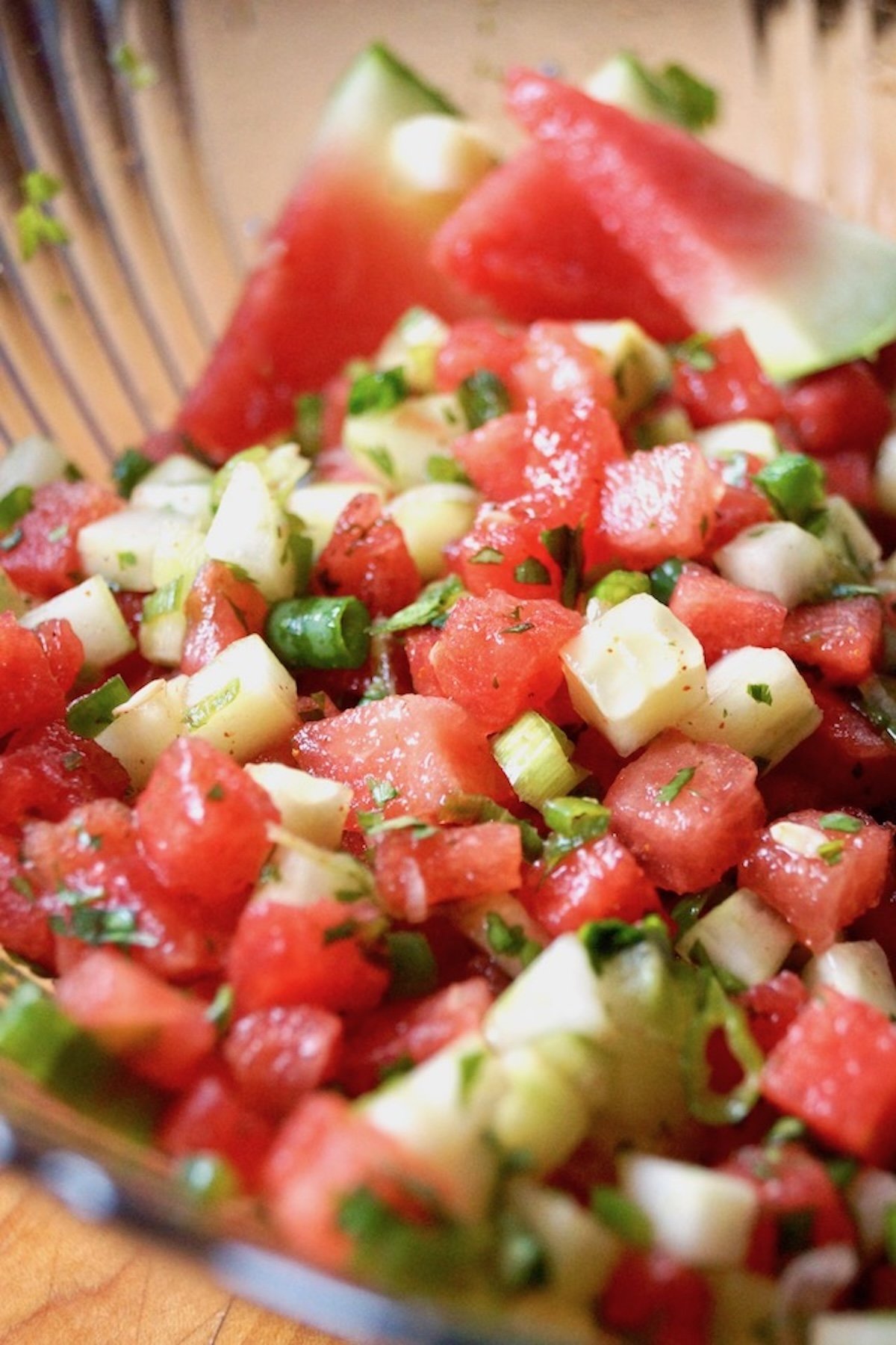 Cucumber and watermelon salsa in a glass bowl.