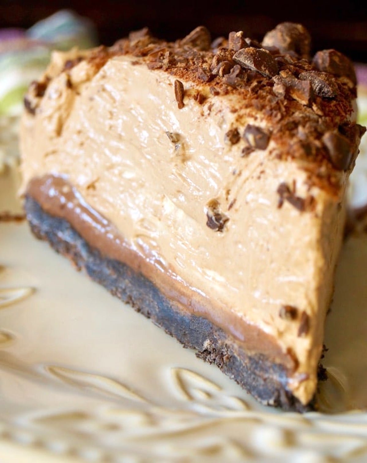 Close up of a large slice of Espresso Chocolate Cheesecake with finely chopped chocolate on top.