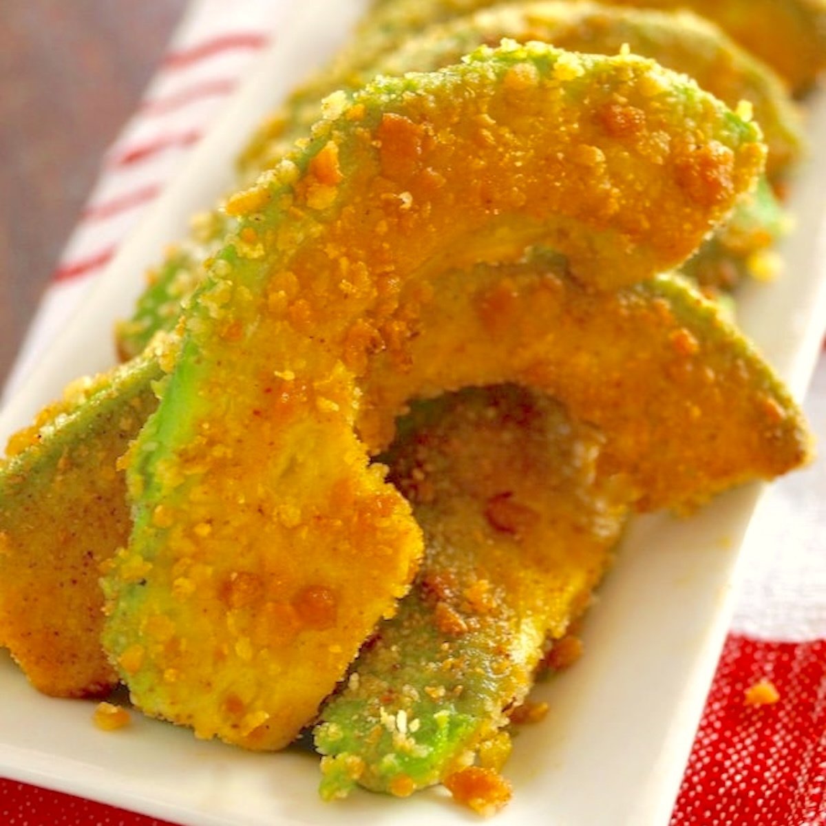 A few Spiced Avocado Fries on a white plate.