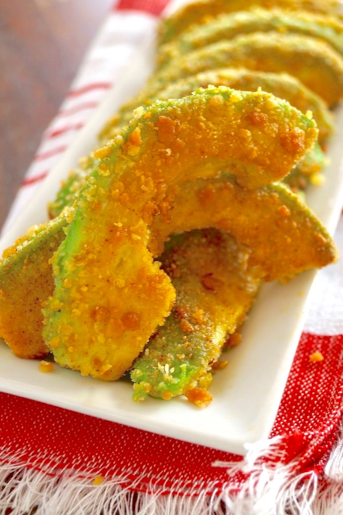 Spiced-Avocado-Fries-Recipe A few Spiced Avocado Fries on a white plate.