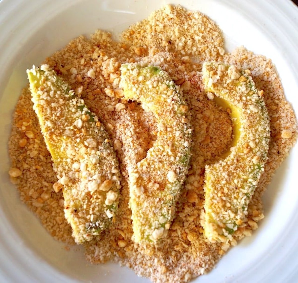Avocado-Fries Three bread crumb-coated slices of avocado.