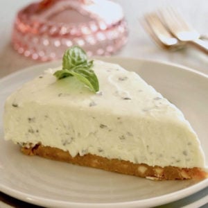 One slice of Sweet Basil Cheesecake with Lemon Crust on white plate