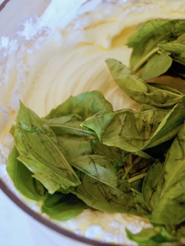 cream cheese and basil leaves in food processor 