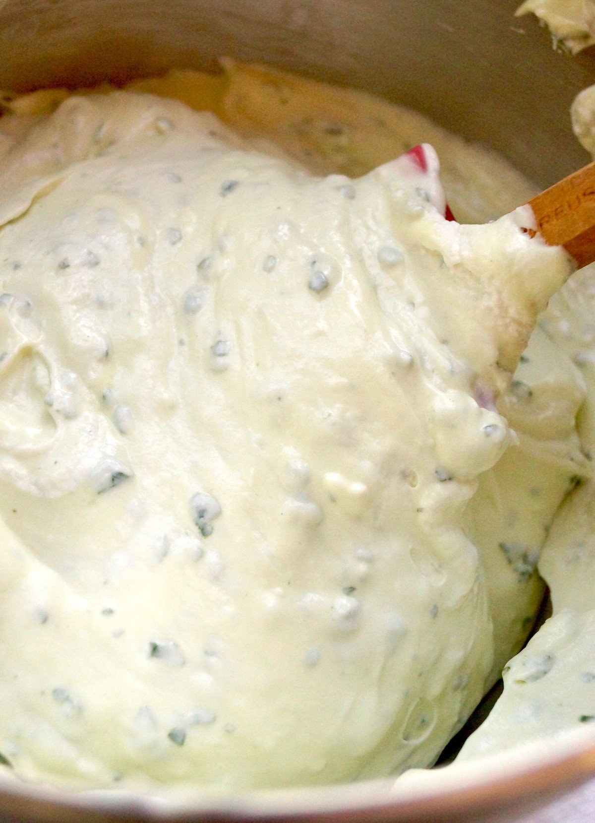 Blended and smooth mixture of whipped cream, cream cheese, sugar and basil.