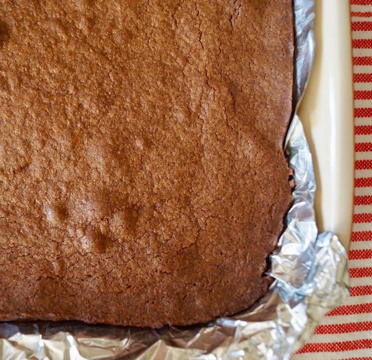 Baked Palm Beach Brownie recipe in pan with foil.