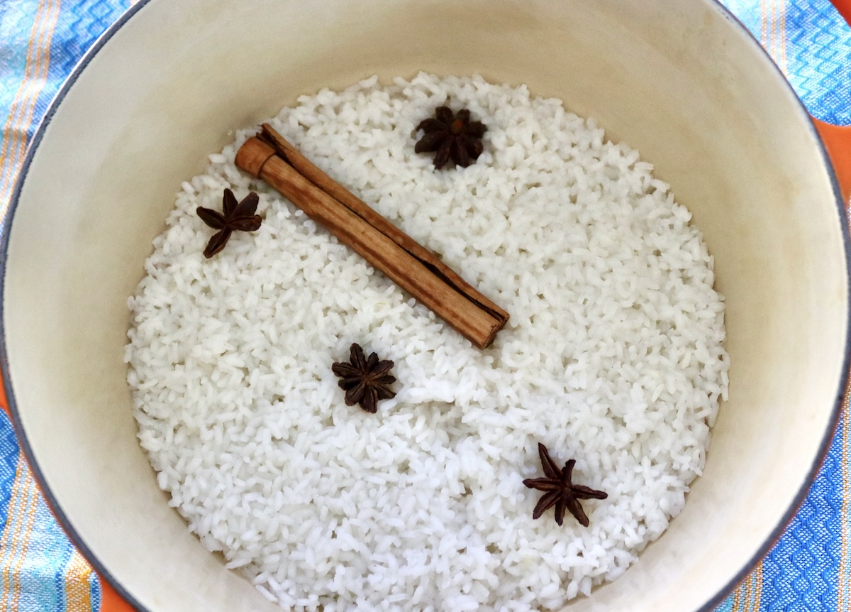 How-to-Make-Rice-Pudding Cooked rice in a Dutch oven with cinnamon stick and star anise.