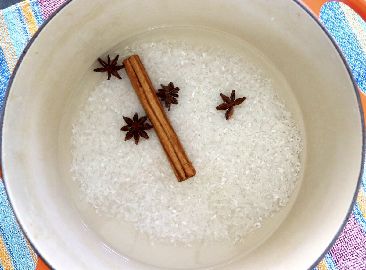 How-to-Make-Rice-Pudding Dutch oven with raw rice, water, cinnamon stick and star anise.